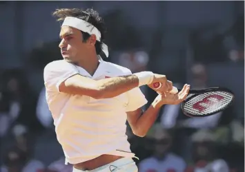  ??  ?? 0 Roger Federer crunches a forehand during his three-set win over Gael Monfils in Madrid.