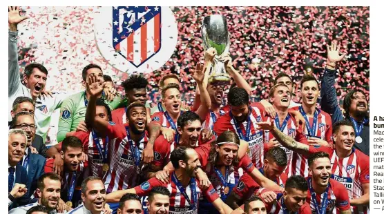  ??  ?? A happy bunch:Atletico Madrid players celebratin­g with the trophy after winning the UEFA Super Cup match against Real Madrid at the Lillekula Stadium in Tallinn, Estonia, on Wednesday. — AFP