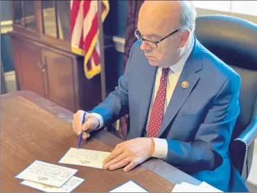  ?? COURTESY OF MHCC ?? U.S. Rep. James McGovern spent time preparing cards of his own for the Cards for Caring initiative.