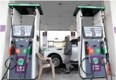  ?? — Reuters ?? A man walks at a petrol station in Riyadh, Saudi Arabia.