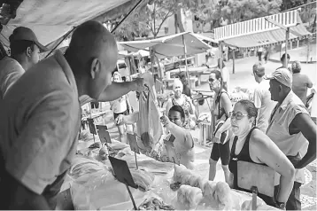  ??  ?? Fish is being sold at a street market in Rio de Janeiro. Brazil’s road to economic recovery has passed another milestone with official data showing that the country finished 2017 with a record trade surplus 40.5 per cent higher than in the previous...