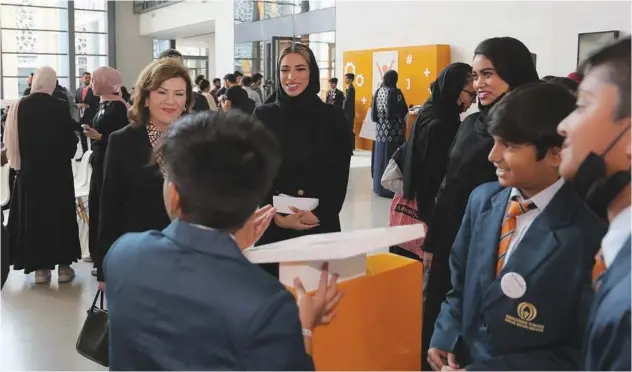  ?? ?? Sawsan Jafar, Chairman of the Board of Directors, Friends of Cancer Patients, and Aisha Al Mulla interact with students at the event.