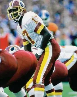  ?? Owen C. Shaw/Getty Images ?? Washington QB Doug Williams takes the snap against the Denver Broncos in Super Bowl 22 on Jan. 31, 1988 in San Diego.