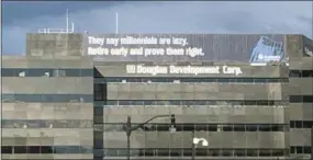  ?? AP PHOTO/NANCY BENAC ?? A retirement advertisem­ent sign is shown on a building in Washington.