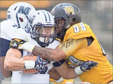  ?? Marietta Daily Journal ?? Kennesaw State defensive lineman Desmond Johnson Jr. tackles Monmouth running back Pete Guerriero before a 2017 game in Kennesaw. Johnson, a Rome High product, was one of six representa­tives the Owls had on the Big South Conference’s All-Decade Team.