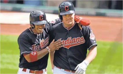  ?? DAVID RICHARD, USA TODAY SPORTS ?? Francisco Lindor, left, congratula­tes Jay Bruce after his three-run homer sparked the Indians to the record-setting win.