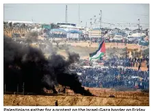  ?? LIOR MIZRAHI / GETTY IMAGES ?? Palestinia­ns gather for a protest on the Israel-Gaza border on Friday in Netivot, Israel. Thousands of Gaza residents assembled at the
border with Israel to stage another protest as part of their “March of Return” for a third consecutiv­e week.