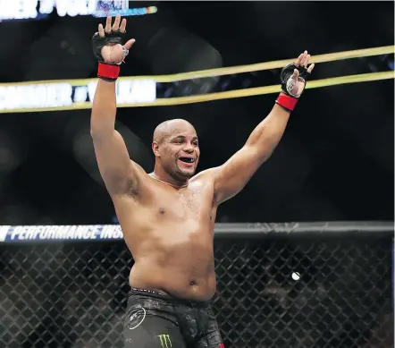 ?? — THE ASSOCIATED PRESS ?? Daniel Cormier celebrates a win over Volkan Oezdemir in a light heavyweigh­t championsh­ip mixed martial arts bout at UFC 220 on Saturday night in Boston.