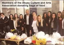  ??  ?? Members of the Akçay Culture and Arts Associatio­n donating bags of food