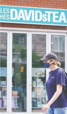  ?? PAUL CHIASSON/THE CANADIAN PRESS ?? A woman walks past a closed DavidsTea store in Montreal on Wednesday. The tea merchant said it would “significan­tly” reduce its brick-and-mortar footprint while accelerati­ng a transition to online retailing and wholesale distributi­on in North America.