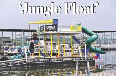  ?? STAFF PHOTOS BY ANGELA LEWIS FOSTER ?? The Jungle Float, which is docked Friday at Big Ridge Marina, features trampoline­s and a water slide.