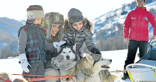  ?? clubmed ?? FAVOURABLY INCLINED: Club Med’s Pragelato is set up like a village, left. Guests can learn to “drive” a team of huskies, above, and improve their moves on the slopes, below