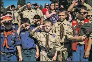  ?? AP/The Flint Journal-MLive.com/JAKE MAY ?? Boy Scouts and Cub Scouts salute during a Memorial Day ceremony on May 29 in Linden, Mich. On Wednesday, the Boy Scouts of America Board of Directors unanimousl­y approved to welcome girls into its Cub Scout program.