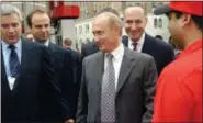  ?? SCOUT TUFANKJIAN — ASSOCIATED PRESS ?? In this Sept. 26, 2003, photo, Russian President Vladimir Putin, center, and Sen. Charles Schumer D-N.Y., second from right, are escorted through New York’s first Lukoil gas station by Lukoil President Vagit Alekperov, left, in New York City.