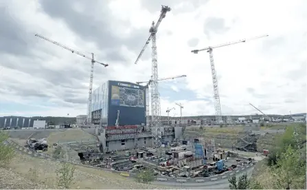  ?? THE ASSOCIATED PRESS FILES ?? Cranes stand at the constructi­on site of the ITER (Internatio­nal Thermonucl­ear Experiment­al Reactor) in Cadarache, France. The vast internatio­nal experiment designed to demonstrat­e that nuclear fusion can be a viable source of clean and cheap energy is...