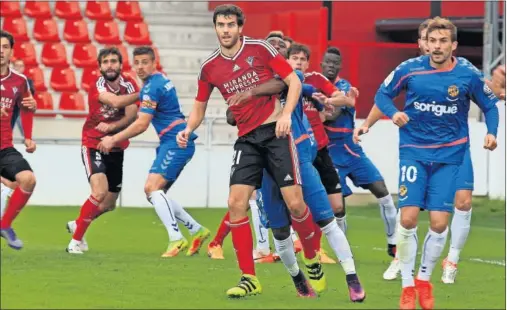  ??  ?? EN DISPUTA. Néstor Salinas es sujetado en una jugada de estrategia del club rojillo en presencia de Muñiz, autor del gol.