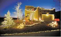  ?? LUIS SÁNCHEZ SATURNO/THE NEW MEXICAN ?? Fernando Ramirez and Grisel Payan’s house in the 4200 block of Vegas de Sueños is the winner of The New Mexican’s 2017 Holiday Display Extravagan­za.