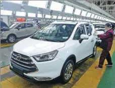  ?? ZHANG DAGANG / FOR CHINA DAILY ?? A technician checks a car at an automobile plant in Hefei, capital of Anhui province.