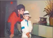  ?? Sundance Institute ?? ROBSON as a child spends time with pop superstar Michael Jackson in a scene from the “Neverland” doc.