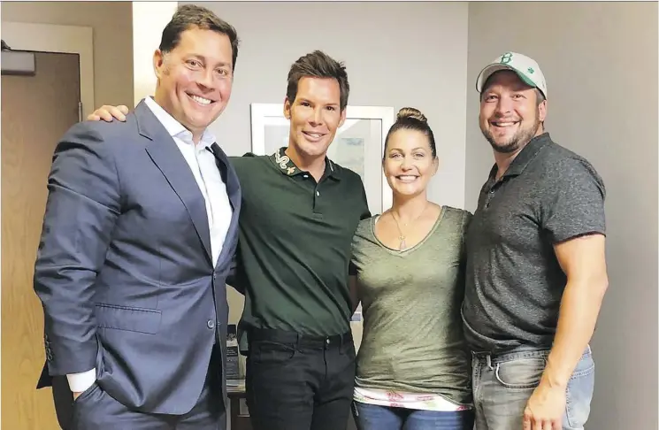  ??  ?? Bill Johnson, left, and his husband, Kraig Wiedenfeld, hope to have a child with the help of surrogate Christina Fenn, seen here with the couple and her husband, Brian Fenn.