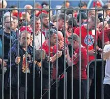  ?? ?? SHAMBLES Fans outside ground amid use of tear gas