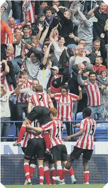  ??  ?? Sunderland celebrate their dramatic, late winner at Bolton, following Zat Knight’s hapless own goal.