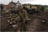  ?? The Associated Press ?? Ukrainian servicemen patrol Sunday in a recently retaken village. north of Kharkiv, east Ukraine