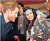  ??  ?? Prince Harry meets a mother and her child at the Virgin Money London Marathon Expo at ExCeL in London yesterday, while the Duchess of Cambridge spoke to runners from Team Heads Together at Kensington Palace