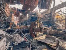  ?? DMYTRO KOZATSKI/VIA AP ?? In this photo provided by Azov Regiment, a Ukrainian soldier stands inside the ruined Azovstal steel plant prior to surrender to Russian forces in May. The photograph­er is now a prisoner of the Russians.