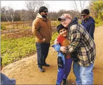  ?? ?? CAROLINE Clarin, hugging Haiwad Massoodi at her farm in Dalton, Minn., said of Patan: “It was like my son came home.”