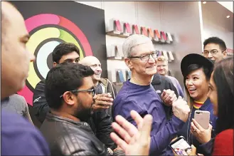  ?? (AFP) ?? Apple CEO Tim Cook greets customers as the new iPhone X goes on sale at an Apple Store on Nov 3 in Palo
Alto, California. The highly anticipate­d iPhone X went on sale around the world Saturday.