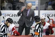  ?? GENE J. PUSKAR — THE ASSOCIATED PRESS ?? Red Wings head coach Jeff Blashill, center, talks with referee Mike Hasenfratz, right, during the first period of a game against the Penguins Sunday.