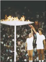  ??  ?? Gymnastics athlete Sandra Henderson (left) and track and field athlete Stephane Prefontain­e light the Olympic Flame during the 1976 Montreal Olympics. (File Photo/AP)