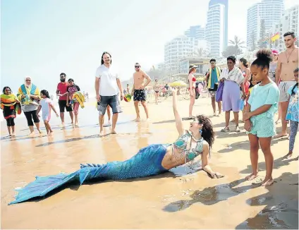  ?? Picture: Jackie Clausen ?? Mermaid Thalia Sklair caused a stir with holidaymak­ers when she ‘washed up’ on Durban’s Umhlanga beach this week, but a recent TV report about some beaches being littered with heroin needles and broken glass is dimming the allure of the city’s beaches.