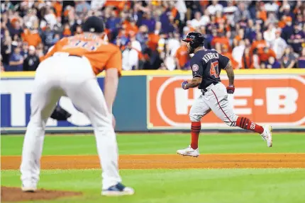  ?? MATT SLOCUM/ASSOCIATED PRESS ?? Houston reliever Will Harris, left, watches Washington’s Howie Kendrick round the bases after yielding a crushing seventh-inning homer that cost the Astros the lead and ultimately the game.