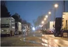  ??  ?? Semi-trucks line up around Kroger supply warehouse on a rain-soaked Tuesday morning where workers are on mandatory overtime.