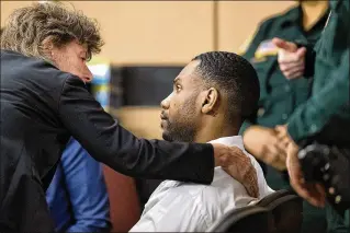  ?? PHOTOS BY ALLEN EYESTONE / THE PALM BEACH POST ?? Public Defender Carey Haughwout confers Thursday with John Chapman at the Palm Beach County Courthouse, where, after more than 14 hours of deliberati­ons spanning two days, a jury convicted him of seconddegr­ee murder in the 2015 stabbing death of...