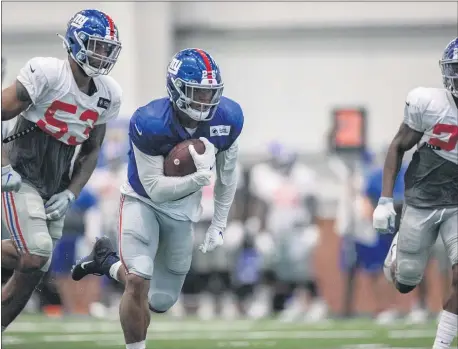  ?? COURTESY OF GIANTS.COM ?? Saquon Barkley (26) runs with the ball during Giants training camp Tuesday in East Rutherford.