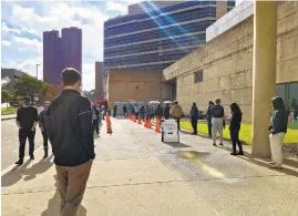  ?? KARL MERTON FERRON/BALTIMORE SUN ?? People wait Nov. 13 for a COVID-19 test at Baltimore Convention Center Field Hospital.