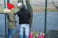  ??  ?? ●●Members of the public leave tributes to Jenson Spellman outside Simmondley Primary School