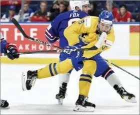  ?? NATHAN DENETTE — THE CANADIAN PRESS VIA AP, FILE ?? In this file photo, Sweden’s Rasmus Dahlin (8) moves the puck around United States’ Adam Fox, rear, during the second period of a semifinal game at the world junior hockey championsh­ip in Buffalo, N.Y.