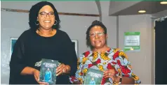  ?? ?? Mrs Fortunate Kufakunesu (left) and Dr Divine Ndhlukula holding the book at the launch ceremony on Friday