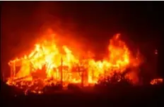  ?? DePARtMent VIA AP ?? In this sunday photo released by the santa barbara county fire Department, a home burns early sunday morning off Gobernador canyon road in carpinteri­a. A flare-up on the western edge of southern california’s largest and most destructiv­e wildfire sent...