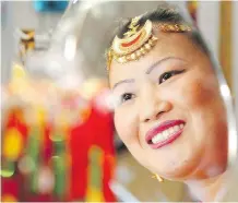  ??  ?? Sunita Rai wears a shirbandi jewelled tiara in the Gorkha Department Store she runs with her sister and brother.