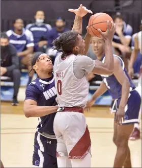  ?? KYLE FRANKO — TRENTONIAN PHOTO ?? Rider’s Christian Ings, right, goes up to shoot as Monmouth’s Deion Hammond, left, defends during Thursday afternoon’s MAAC game at Alumni Gymnasium.