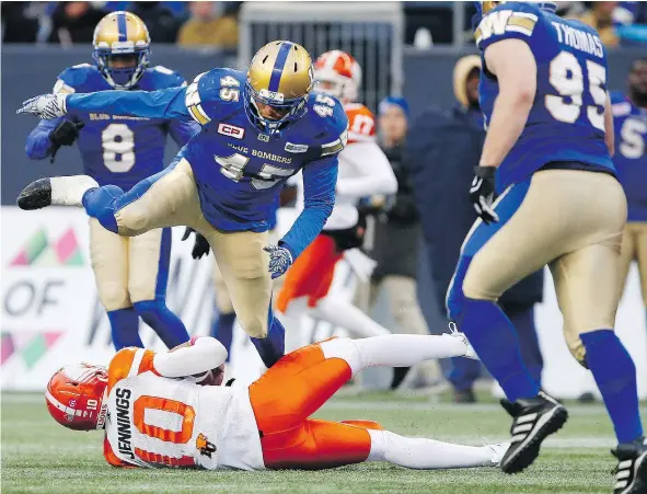  ?? — THE CANADIAN PRESS FILES ?? Winnipeg Blue Bombers’ Jovan Santos-Knox leaps over B.C. Lions quarterbac­k Jonathon Jennings during the second half of CFL action in October 2017. Jennings is looking to bounce back from last year when he lost his starting job to Travis Lulay.