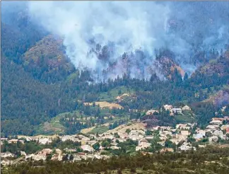  ?? EPA ?? A helicopter drops water over burning Waldo Canyon on the edge of Colorado Springs on Thursday.