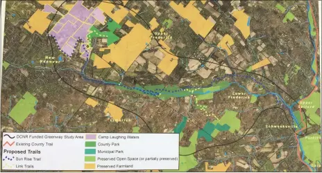  ?? EVAN BRANDT — MEDIANEWS GROUP ?? The large purple area in the top left is Camp Laughing Waters. The orange-colored parcels are preserved open space and the green parcels are parks.