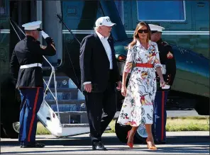  ?? AP/CAROLYN KASTER ?? President Donald Trump and first lady Melania Trump walk Sunday from Marine One at the Morristown Municipal Airport in Morristown, N.J., toward Air Force One for their return to Washington, D.C., from Trump National Golf Club in Bedminster, N.J.