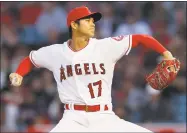  ?? Jae C. Hong / Associated Press ?? AP writer Tim Dahlberg proposes to make each team have a two-way player like Shohei Ohtani. The player must pitch at least once a week and be in the starting lineup at least two other days to hit.